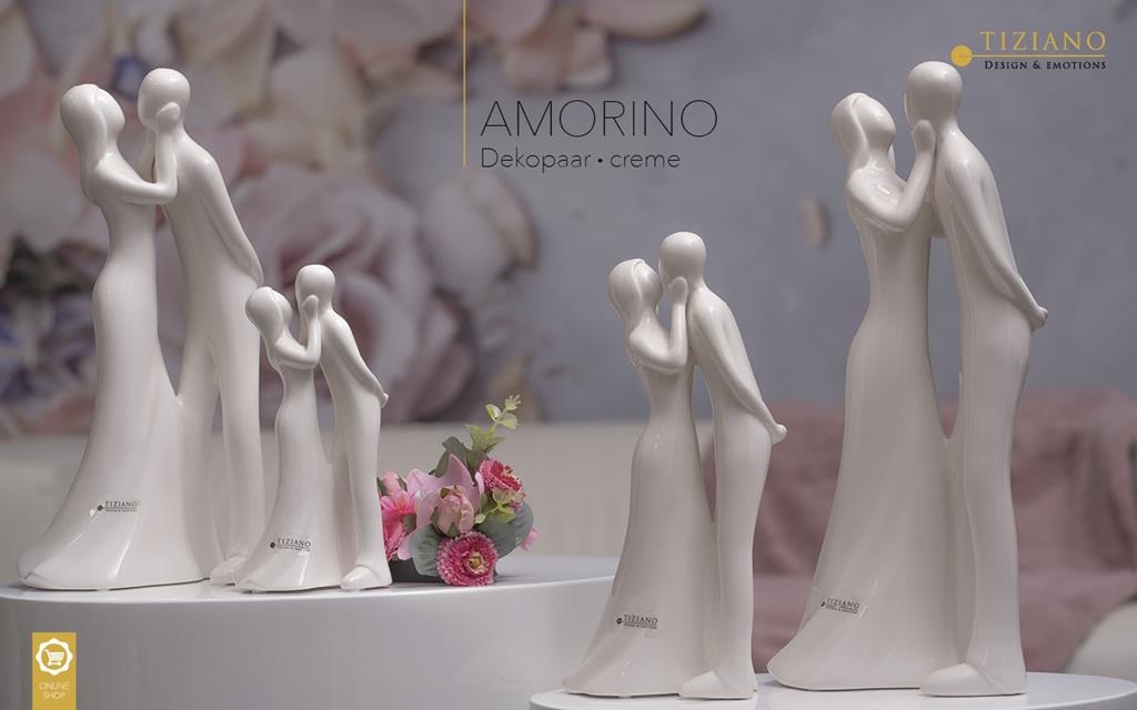 Dekorative Figuren eines Paares in inniger Umarmung, in elegantem Design und cremigen Farbton.